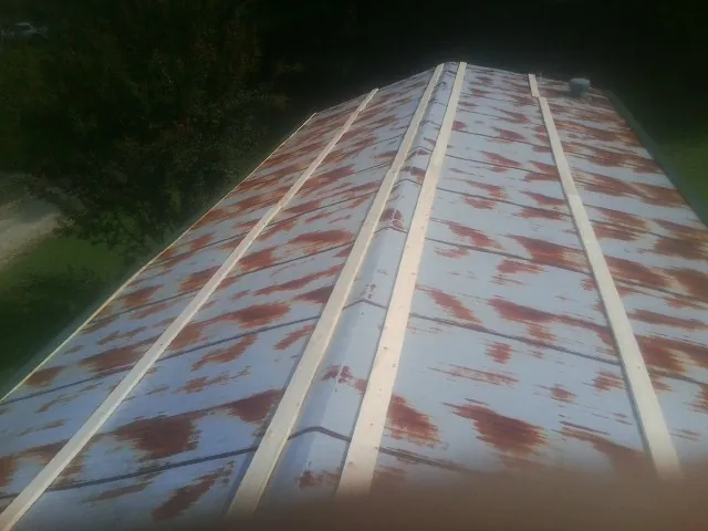 Rusted metal roof panels with new wood purlins before replacement — Storm Damage Roof Repair in Lompoc by Roofing Brothers